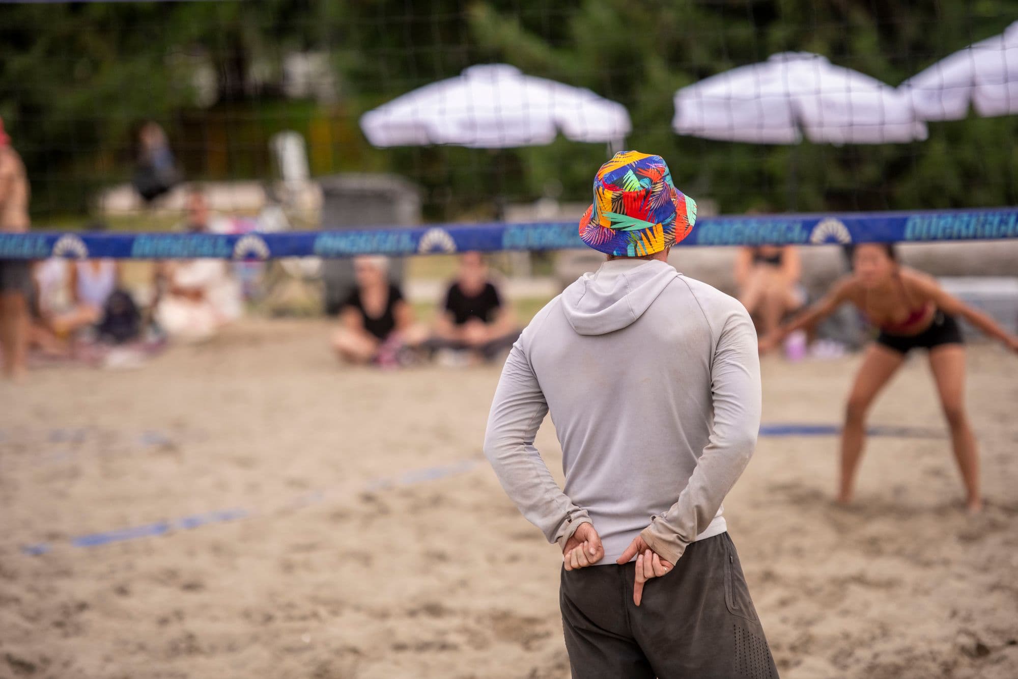 Beach volleyball player signaling a block